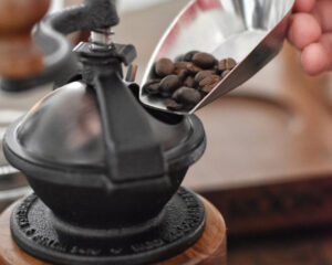Grinding fresh coffee beans with the Camano Coffee Mill manual coffee grinder made in usa