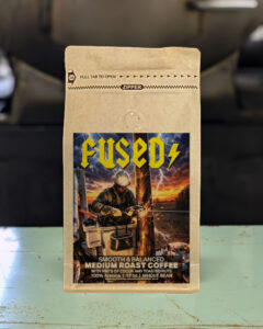 12oz bag of Fused medium roast whole bean coffee blend from Red Rooster Trading Company with notes of cocoa and toasted nuts